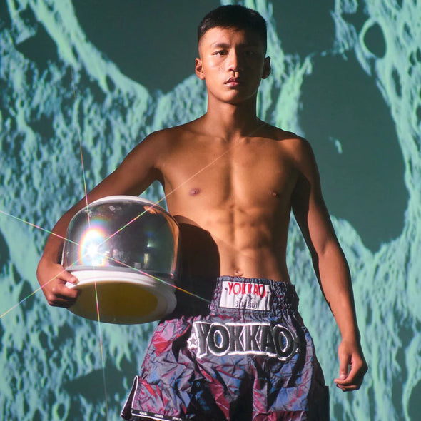 Man holding a glass bowl with a colorful background