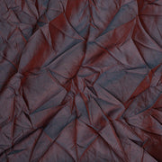Close-up of a textured red fabric with folds