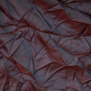 Close-up of a textured brown fabric with folds