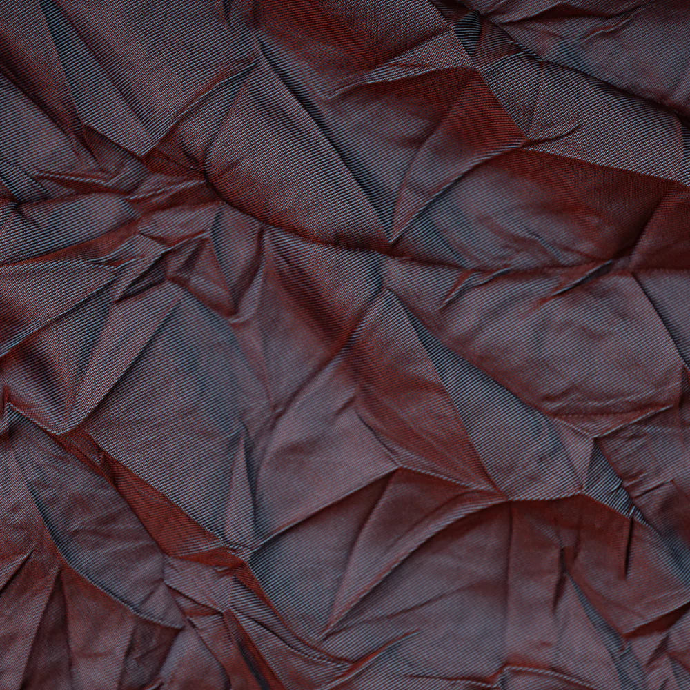 Close-up of a textured brown fabric with folds