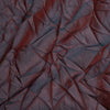 Close-up of a textured red fabric with folds