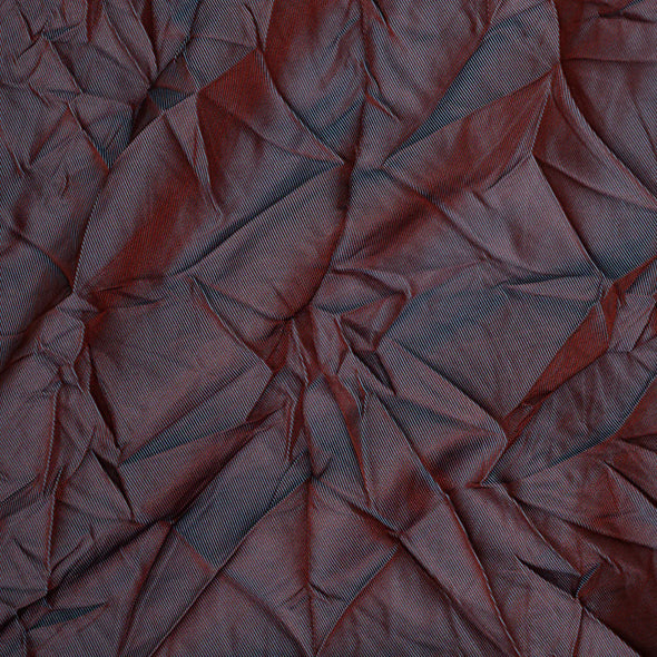 Close-up of a textured red fabric with folds