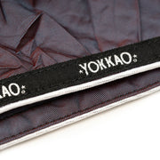 Yokkao branded strap on a textured background
