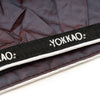 Yokkao branded strap on a textured background