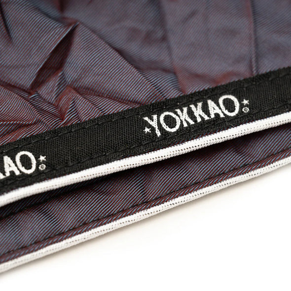 Yokkao branded strap on a textured background