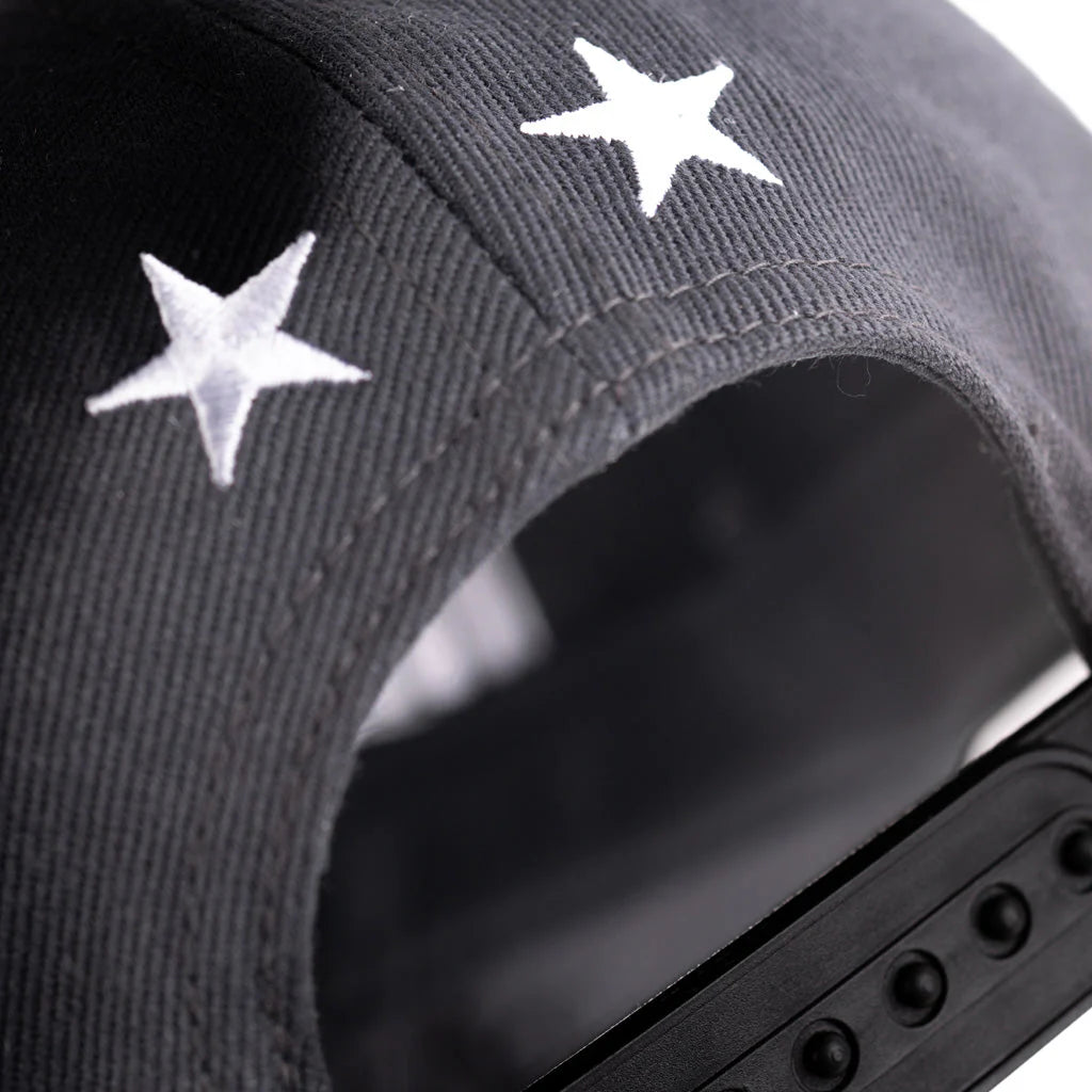 Black cap with white star patterns on a blurred background