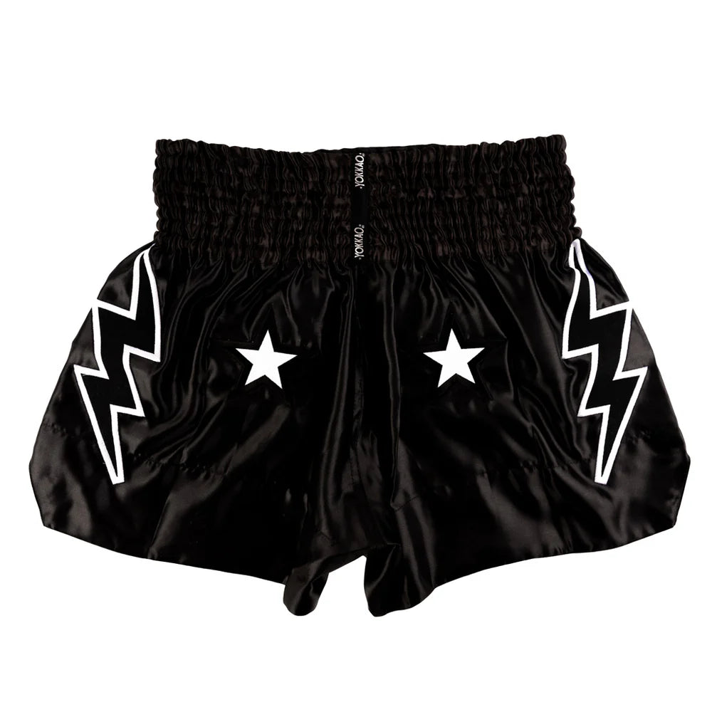 Black shorts with white lightning bolt and star designs on a white background