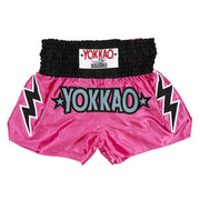 Pink Yokkao boxing shorts with black lightning bolt designs on a white background