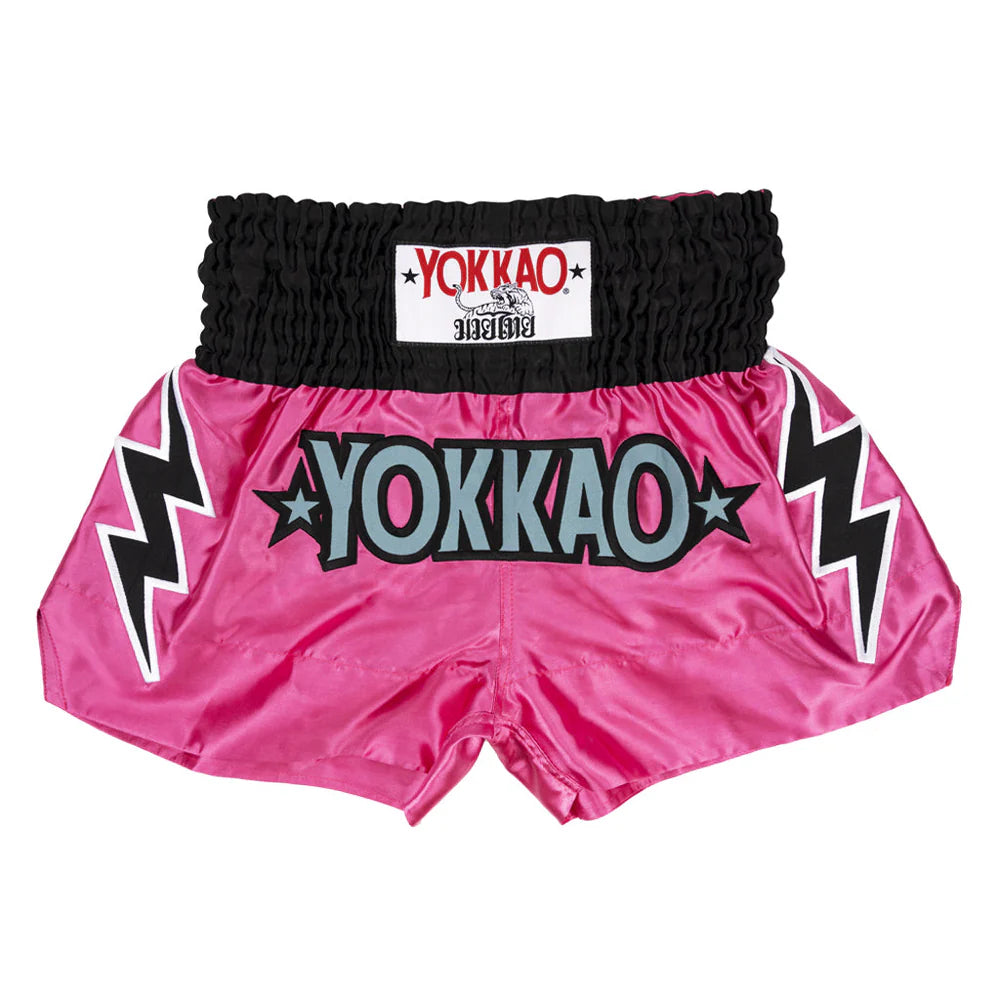 Pink Yokkao boxing shorts with black lightning bolt designs on a white background