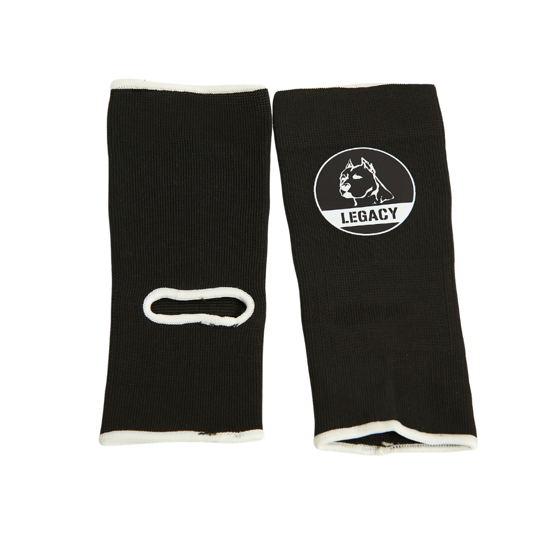Legacy Ankle Support Guards in black, featuring the Legacy logo, designed to provide stability and protection for martial arts training.