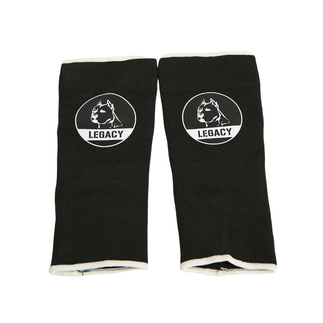 Legacy Ankle Support Guards in black, featuring the Legacy logo, designed to provide stability and protection for martial arts training.