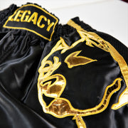 Legacy Golden Era Muay Thai shorts with traditional Thai boxing cut and gold embroidered design