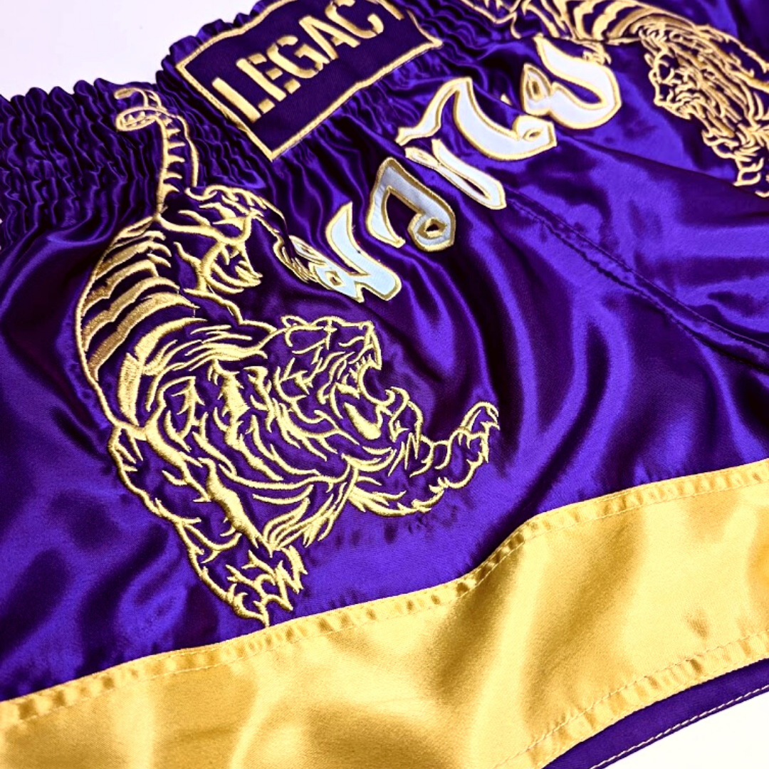 Legacy Twin Tigers Muay Thai shorts with custom embroidery and traditional Thai boxing design