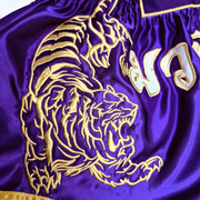 Legacy Twin Tigers Muay Thai shorts with custom embroidery and traditional Thai boxing design