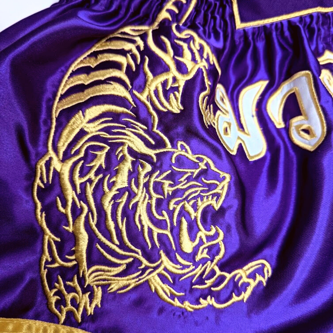 Legacy Twin Tigers Muay Thai shorts with custom embroidery and traditional Thai boxing design