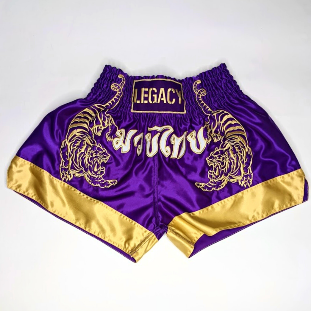 Legacy Twin Tigers Muay Thai shorts with custom embroidery and traditional Thai boxing design