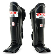 Yokkao Matrix black Muay Thai shin guards for sparring and training with double Velcro straps and premium synthetic leather
