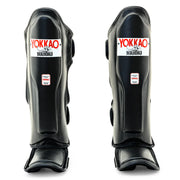Yokkao Matrix black Muay Thai shin guards for sparring and training with double Velcro straps and premium synthetic leather